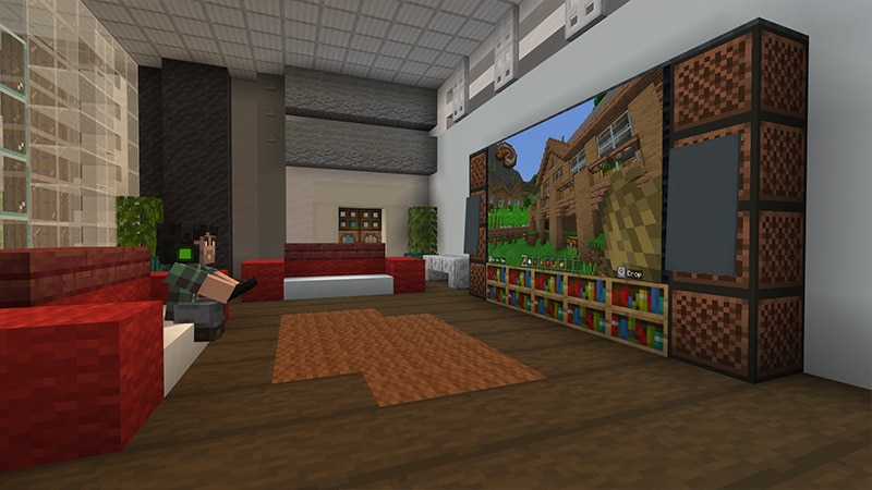 A living room in the Good Game world with a large screen and a player on the sofa